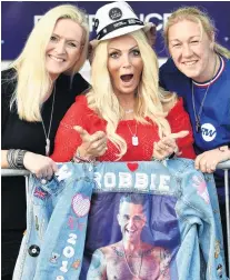  ?? PHOTO: PETER MCINTOSH ?? Happy campers . . . Robbie Williams fans (from left) Amanda Bail, Karen McCuskey and Bec Christou still look fresh and lively after waiting all night to get prime viewing spots for Saturday night’s concert at Forsyth Barr Stadium. The image of Robbie...