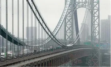  ??  ?? The George Washington Bridge is blanketed with snow on Friday, in Fort Lee, New Jersey.
