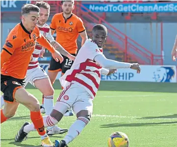  ??  ?? Top: Marc Mcnulty strokes the ball into the Hamilton net to give United an early lead; above: Hamilton’s Hakeem Odoffin challenges Louis Appere in the home box.