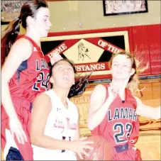  ?? RICK PECK/SPECIAL TO MCDONALD COUNTY PRESS ?? McDonald County’s Rita Santillan gets sandwiched by Lamar’s Lauren Compton (24) and Lauren Morgan (23) while going to the basket during Lamar’s 44-37 win on Jan. 4 at MCHS.