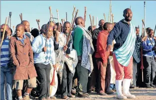  ?? FILE PHOTO: ITUMELENG ENGLISH ?? Hundreds of striking miners chant pro-Amcu songs as they march in Marikana. The writer says that workers will be required to use their savings as “grants” so that the state does not have to pay them.