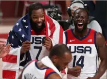  ?? Ezra Shaw/Getty Images ?? Kevin Durant, left, and Draymond Green celebrate gold in men’s basketball. Team USA defeated France, 87-82, in the final early Saturday morning.