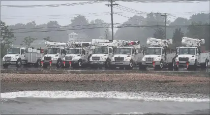  ?? Brian A. Pounds / Hearst Connecticu­t Media ?? Utility trucks are staged to deal with any damage from Tropical Storm Henri at Gulf Beach in Milford on Monday, Aug. 23.