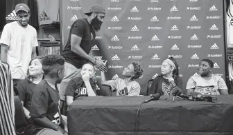  ?? Juan Figueroa / Staff photograph­er ?? The Rockets’ James Harden greets Jamyrion Lee, 11, among other attendees at the Adidas and James Harden ProCamp on Friday.