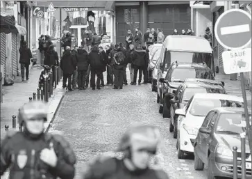  ?? Lionel Bonaventur­e ?? FRENCH POLICE gather in north Paris after the fatal shooting of a man thought to be wearing an explosives vest. He carried a piece of paper that bore Islamic State’s f lag and a claim of responsibi­lity, authoritie­s said.