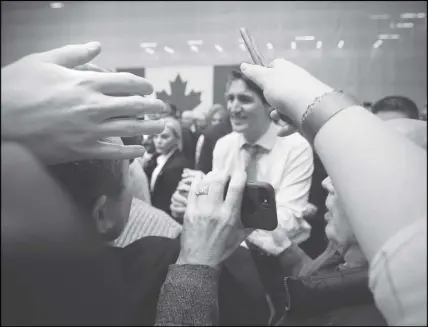  ?? CP PHOTO ?? Supporters Winnipeg. reach out to Prime Minister Justin Trudeau after a town hall meeting at the University of Manitoba in