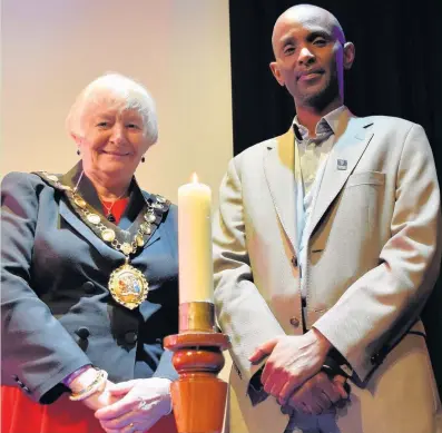  ??  ?? Eric Eugene Murangwa, a survivor of the 1994 genocide against the Tutsi in Rwanda, spoke at Bridgend’s Holocaust Memorial Day event. He is pictured with Bridgend county mayor Pam Davies