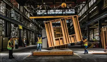  ?? CHRISTIE HEMM KLOK / THE NEW YORK TIMES ?? Workers build modular homes recently at a factory in Vallejo, Calif. Despite other good economic numbers, homebuyers are encounteri­ng higher mortgage rates, one reason the housing market has been faltering even as other economic indicators like hiring...