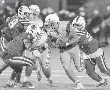  ?? MICHAEL LAUGHLIN / SUN SENTINEL ?? Stranahan running back Sincere Rodriguez breaks through the Fort Lauderdale defense during their game Friday. Rodriguez and the Mighty Dragons rolled to a 36-0 victory over their crosstown rival.