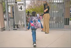  ??  ?? Kindergart­ner Angel Hernandez leaves after the first day of in-person learning at Maurice Sendak Elementary School.