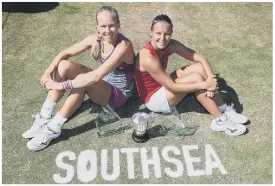  ??  ?? CHAMPIONS Kirsten Flipkens, right, and Johanna Larsson with their trophies after winning the ladies’ doubles in 2018