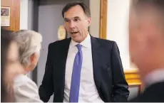  ?? BEN NELMS/THE CANADIAN PRESS ?? Finance Minister Bill Morneau meets small business owners in Vancouver Tuesday. The owners fear the proposed tax changes will add to the enormous tax burden they already face.