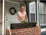  ?? NICHOLAS BUONANNO — NBUONANNO@ TROYRECORD.COM ?? Ronda Lyons, who is a step-daughter to the late founder of Unity House Mary Jane Smith, places some new flowers in a flower bed outside of one Unity House’s properties in Troy on Mary Jane Smith Day.