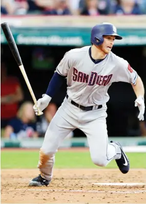  ??  ?? San Diego Padres' Cory Spangenber­g hits against Cleveland Indians starting pitcher Corey Kluber in the fifth inning of a baseball game Tuesday in Cleveland. Spangenber­g hit into a fielder's choice and was safe at first base. Hector Sanchez scored on...