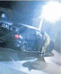  ??  ?? The perpetrato­r is caught on camera at Augustus Autos wandering through the premises at 2.25am yesterday morning.