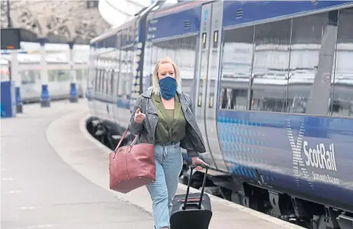  ?? Photograph by Kath Flannery ?? MANDATORY: A passenger at Aberdeen station observes the new rules about face coverings on public transport.