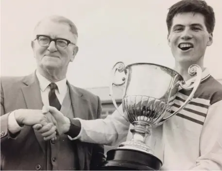  ??  ?? Mitchels skipper Derek Breagy with Sean Murray and the Junior Championsh­ip trophy in 1992.