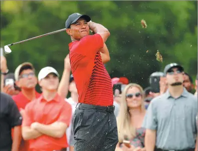  ?? MIKE CARLSON / AP ?? Tiger Woods tees off on the 15th hole during the final round of the Valspar Championsh­ip on Sunday in Palm Harbor, Florida, where he finished second behind Paul Casey.