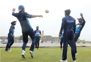  ?? — AFP ?? Sri Lankan cricketers play football during a training session at the Galle Internatio­nal Stadium.