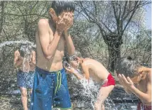  ??  ?? Children wash outside the destroyed Moria migrant camp on Lesbos.