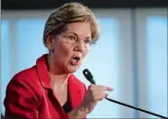  ?? PABLO MARTINEZ MONSIVAIS/AP PHOTO ?? Sen. Elizabeth Warren, D-Mass., gestures while speaking at the National Press Club in Washington on Tuesday. Warren wants a lifetime ban on members of Congress from getting hired as lobbyists after they leave public office. She also wants to prohibit lawmakers from owning or trading individual stocks while in office.