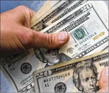  ?? AP 2018 ?? Public officials and health experts have said that the risk of transferri­ng the virus person-to-person through the use of banknotes is small. But that has not stopped businesses from refusing to accept currency.