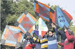  ?? AFP ?? Protesters use kites as placards during a demonstrat­ion in support of farmers against the government’s agricultur­al reforms, in Amritsar on Tuesday.