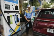  ?? RAJANISH KAKADE — THE ASSOCIATED PRESS ?? An employee of a Bharat petroleum fuel station fills petrol in a vehicle in Mumbai, India, on Saturday.