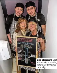  ??  ?? Bog standard Staff at the cafe promoting their toilet-twinning campaign