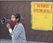  ?? DANIA MAXWELL Los Angeles Times ?? ACTIVISTS with the group Defend Boyle Heights taped a notice on Councilman Jose Huizar’s garage door after his arrest on corruption charges.