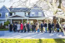  ?? DAVID WILLIAMS/BLOOMBERG ?? Fans line up for the estate sale at the refurbishe­d Grey Gardens house, in East Hampton, N.Y., last month.