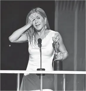  ??  ?? A shocked Jennifer Aniston accepts the award for performanc­e by a female actor in a drama series for her role in Apple TV Plus' “The Morning Show.”