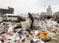  ?? ?? An unidentifi­ed man collects waste for recycling, as the ongoing citywide clean-up campaign moves into high gear. — Picture: Memory Mangombe