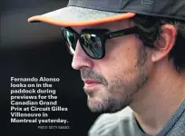  ?? PHOTO: GETTY IMAGES ?? Fernando Alonso looks on in the paddock during previews for the Canadian GrandPrix at Circuit Gilles Villeneuve in Montreal yesterday.