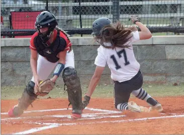  ??  ?? Gordon Lee’s Paxton Grimes slides around Hawkinsvil­le catcher Nadia Sloan to bring in a run during the Lady Trojans’ sweep of the Red Devils last Wednesday. (Messenger photo/Scott Herpst)