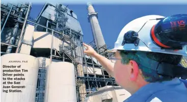  ??  ?? JOURNAL FILE Director of production Tim Driver points to the stacks at the San Juan Generating Station.