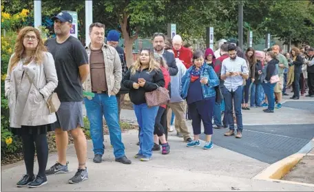  ?? Loren Elliott Getty Images ?? EARLY VOTERS wait in Houston last week. Texas is on track to see over 3 million more people vote in this year’s midterm than in 2014.