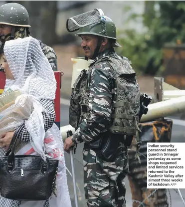  ?? AFP ?? Indian security personnel stand guard in Srinagar yesterday as some shops reopened and limited services returned to the Kashmir Valley after almost three weeks of lockdown