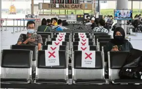  ??  ?? Keeping their distance: People waiting at the Puteri harbour internatio­nal ferry terminal in Kota iskandar in Johor. in a bid to promote social distancing, the management of the ferry terminal had put up ‘no-seat’ stickers in between seats at the waiting area.