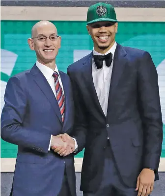 ?? AP PHOTO ?? SHAKE ON IT: Forward Jayson Tatum, taken by the Celtics with the third overall pick, poses with NBA commission­er Adam Silver last night in New York.