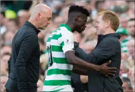  ??  ?? Neil Lennon embraces Vakoun Bayo after the striker was substitute­d