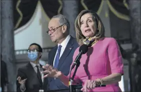  ?? Stefani Reynolds / Bloomberg ?? Senate Minority Leader Charles Schumer, center, listens as House Speaker Nancy Pelosi speaks in Washington on Friday. Negotiatio­ns with the White House have stalled.