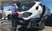  ??  ?? A petrol station attendant has to stand on a bin to work on the extra-high vehicle.