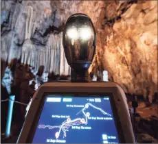  ?? Associated Press ?? Persephone guides the visitors inside Alistrati cave, about 84 miles northeast of Thessaloni­ki, Greece. Persephone, billed as the world’s first robot used as a tour guide inside a cave, has been welcoming visitors to the Alistrati cave, since mid-July.