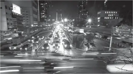  ?? Associated Press ?? ■ Cars cross the Queensboro Bridge in New York City on Jan. 11 in this file photo. The Trump administra­tion is citing safety to justify freezing gas mileage requiremen­ts. A draft of a regulation prepared this summer would freeze an Obama-era program to...