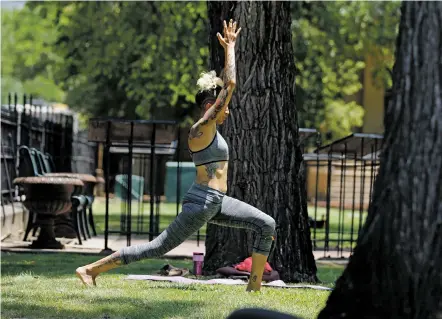  ?? LUIS SÁNCHEZ SATURNO/THE NEW MEXICAN ?? Krista Talley of Santa Fe does yoga Thursday at Cathedral Park amid sunny weather and mild temperatur­es. Today’s forecast again calls for sunny skies and a high of 86 degrees and low of 52.
