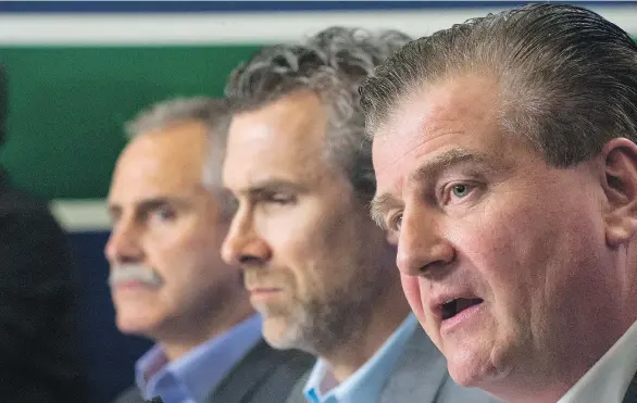  ?? JENELLE SCHNEIDER/ FILES ?? Vancouver coach Willie Desjardins, left, president Trevor Linden and general manager Jim Benning, right, are set to get working on plans for next season.