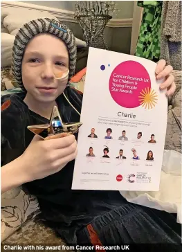 ?? ?? Charlie with his award from Cancer Research UK
