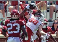  ?? KEVIN JAIRAJ/USA TODAY SPORTS ?? Oklahoma cornerback D.J. Graham (back center) makes an intercepti­on in front of Nebraska wide receiver Levi Falck (88) during the fourth quarter on Saturday at Gaylord Family-oklahoma Memorial Stadium in Norman, Okla.