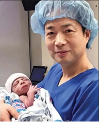  ??  ?? Pioneering: Dr John Zhang with the baby boy, who carries the DNA of three people